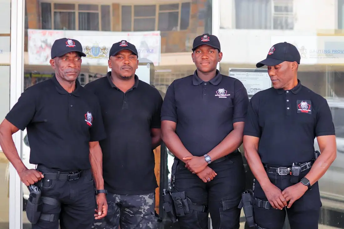 Nsika Protection Services officers in branded uniform standing on post outside a client building